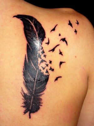 feminine feather tattoos for shoulder blade girls